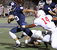 Junior Harrison Quiel pushes past Canyon on Oct. 2 during the Pink Out home game.