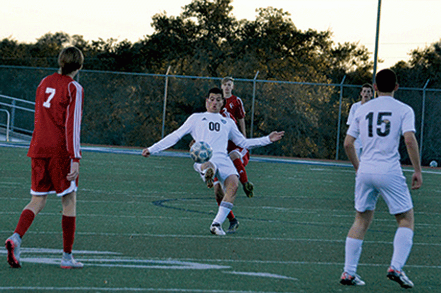 A soccer player kicks the ball away from rival Canyon players on Feb. 2, the game before the game with Clemens.