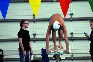 A swimmer prepares to dive into the water during the Jan. 30 district meet. Photo by: Alderete