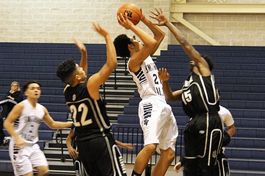 Freshman Sean Bolds jumps, shooting the ball as Steele players try to block him on Jan. 26. 