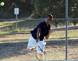 Junior Daniel Hinojosa hits the ball to the other side of the net on Oct. 13