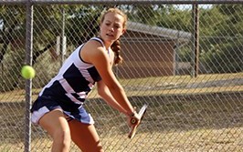 Junior Lauren Basset practices for the upcoming tennis match against Steele High School.