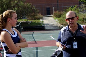 Coaching with a Passion: Head coach Thomas Mayton coaches junior Lauren Bassett and the varsity tennis team early morning Sept. 1. They prepared for the upcoming competitions.