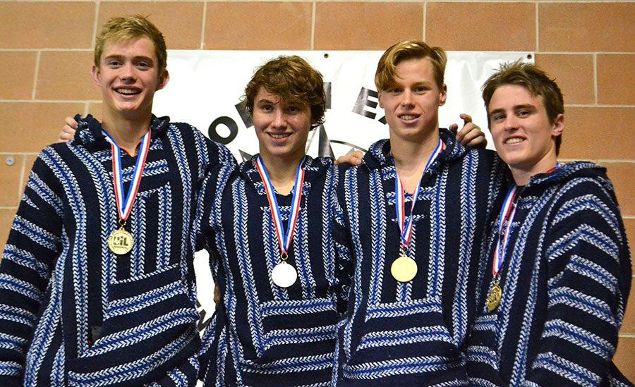 Freshmen Konnar Klinksiek, and Shaun Besch pose with senior Clayton Taylor and junior Ian Ogrodnik after their first place win in the 200 medley relay at regionals.
