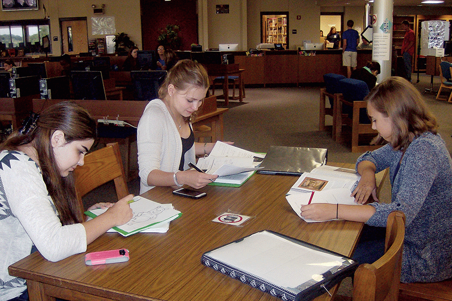 Left to right, sophomores Riley Bridgewater, Bridget Higgins, and Audrey Wood study together in the library on Oct. 1. 
