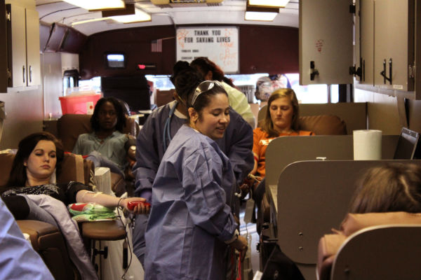 Hannah Pittman donates blood during the 2015 blood drive.