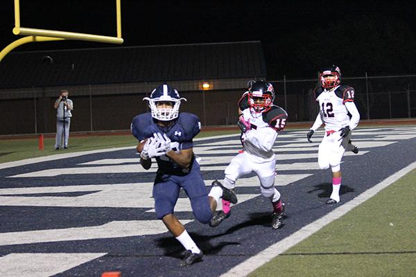Junior Edwin Martinez makes a reception for the touchdown during the game. The football team downed the Thunderbirds 37-0 for the homecoming win.