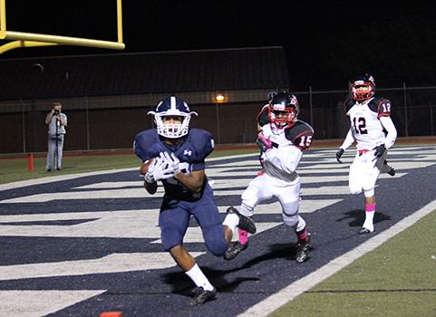 Junior Edwin Martinez scores a touchdown in the Homecoming game Oct. 7. The team won in a 37-0 victory.