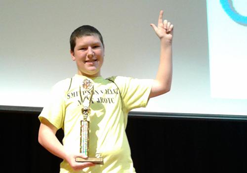 Sophomore Gage Clark gets his gun up after winning first place at the chess tournament.