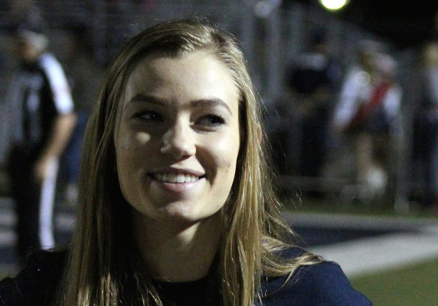 Senior McKaelyn Clark works the sidelines covering the Judson football game on Oct. 28.