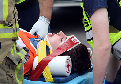 Crash victim Lindsey Curtis gets loaded on a stretcher by emergency medical personnel during Shattered Dreams Thursday.