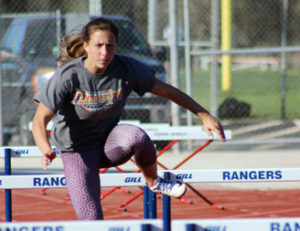 Senior Megan Mann practices hurdles at Ranger Stadium during an after school practice.