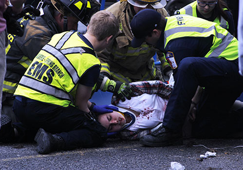 Emergency medical personnel, including Jacob Seago and Katie Ecoff, tend to accident victim Lindsey Curtis during the Shattered Dreams presentation.