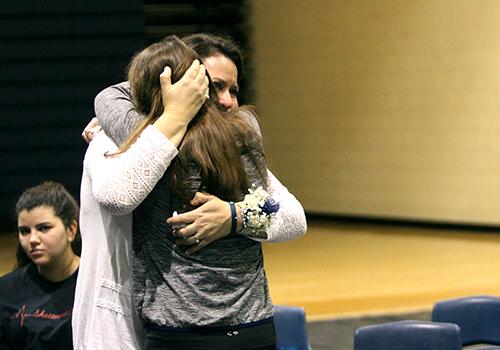 Curriculum instructional coach Sally Bratton embraces her daughter Kathleen after giving her testimony.
