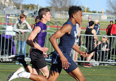 Freshman Greg Eggleston carries baton for team during Tiger Relays at Dripping Springs on Feb 25.