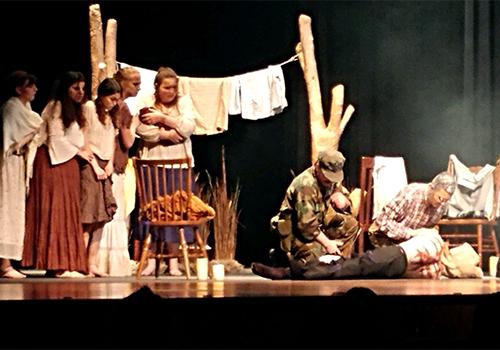 Left to right: Linsey Curtis, Ana Elliot, Kaylee Underwood, Katie Box, Madeline Kutac, Jack Mobley and LJ Haider examine River Thompson as the body.