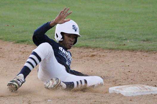 Junior outfielder Eric Reece slides into 3rd base during the teams tournament in Laredo.