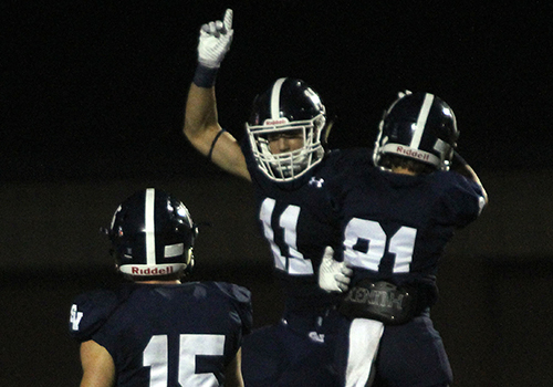 After scoring a touchdown, senior wide receiver Ricky Rios celebrates with junior wide receiver Nick Kuykendall and senior wide received Brance Anderson during the 54-0 shutout of East Central on Sept. 22