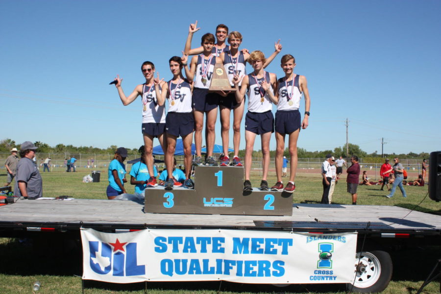 The boys cross country team celebrates after a first place finish at the Regional Championships on Oct. 23.