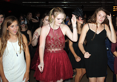 Seniors Olivia Kershner, Nicole Langley and Emma Sipple dance to the Cupid Shuffle at the Homecoming dance Saturday.