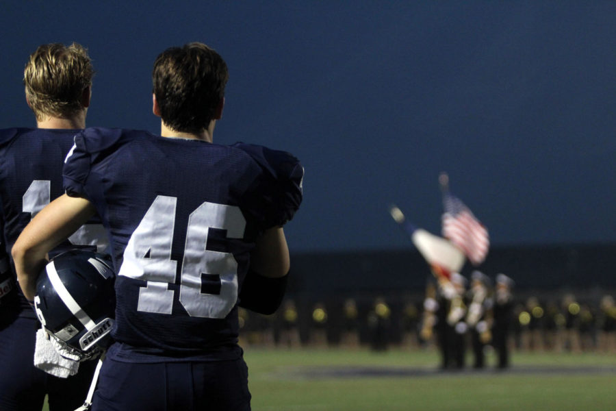 STAR+SPANGLED+SALUTE+With+his+hand+over+his+heart%2C+Junior+Dane+Spencer+stands+on+the+field+during+the+National+Anthem+at+the+Homecoming+Game+on+Sept+30.+None+of+the+varsity+players+have+kneeled+or+stood+with+a+fist+raised.