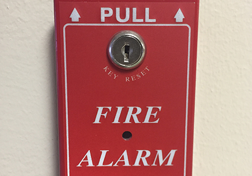 The fire alarm next to the doors outside of A-wing