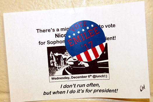 A sticker for Emilee Chilldres is on top of a poster for Nicole Sandoval in A wing. Both are running for sophomore class president.