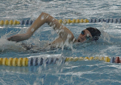 Senior Emily competes in the womens 100 freestyle at the Reagan meet. 