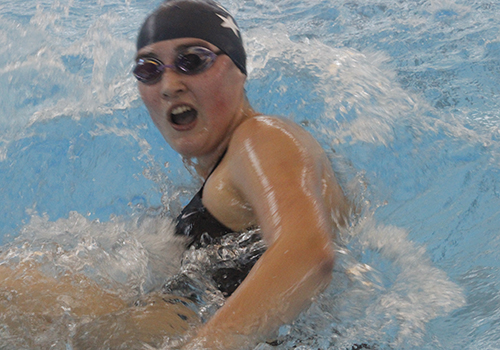 Turning at the wall, junior Jasmine Ballard swims her 200 individual medley.  