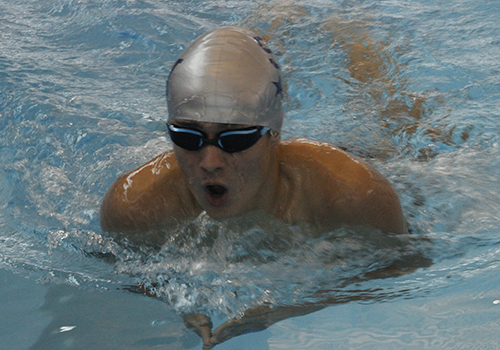 Senior Ronan Kelly swims breaststroke in the 200 individual medley at the dual meet against Reagan Jan 6. 