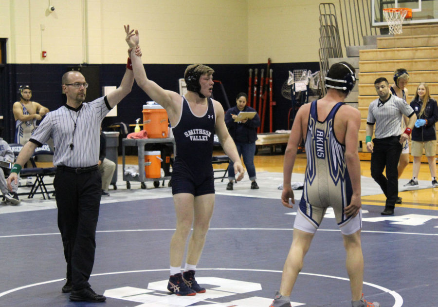 As+the+referee+raises+his+right+hand%2C+senior+Carson+Palumbo+claims+victory+over+an+Akins+wrestler+on+Feb.+7+at+home.+Palumbo+advances+to+region+this+weekend+in+San+Antonio.