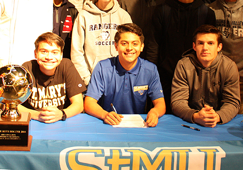 Johnathan Diaz, Nathaniel Diaz and Luis Green pose as Nathaniel Diaz signs his letter of intent. He will play soccer at Saint Marys University. Its close to home, he said.   