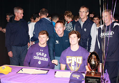 CJ Kuehler, coach Jeff Shinn and Jacob Zuber pose at the signing table. Kuehler and Zuber signed to play football at the University of Mary Harding Baylor. The school had a winning tradition, good coaching and a beautiful environment, Kuehler said.