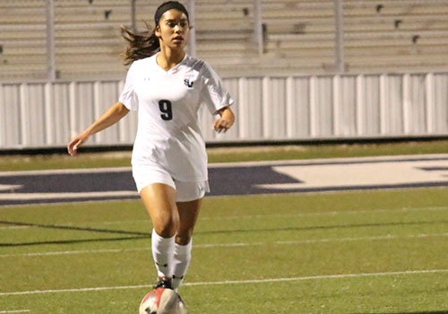 Senior Gaby Valdez pushes the ball up the field during the teams 3-1 over Clemens at home on Mar 9.