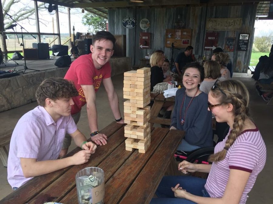 James Lambson and Liam Weeks play Jenga with Sequoia White and friend at Spechts Store spirit night on March 4.