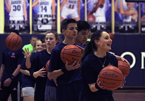 Warming up for the faculty-student basketball game on Wednesday are ROTC cadets Kamdyn Matthews, Catelyn Mitchell, Christian Welch and Lynnea Seiler.