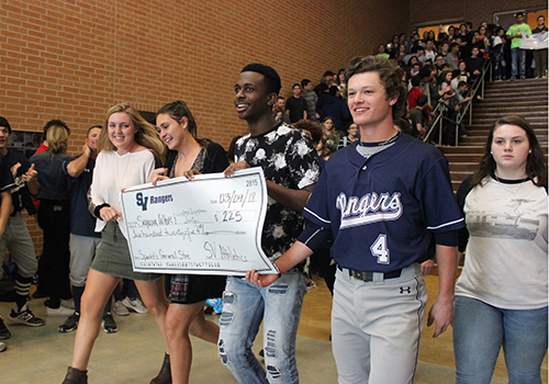 Smithson Valley Athletics representatives present a check for the $225 raised during the Spechts General Store Spirit on March 4.