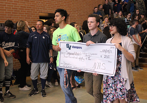 NHS officers Bobby Palomin, Joseph Miller and Maria Rocha carry their organizations check for $250.