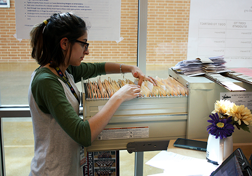 Senior Danielle Bateman files papers in student services on April 4.