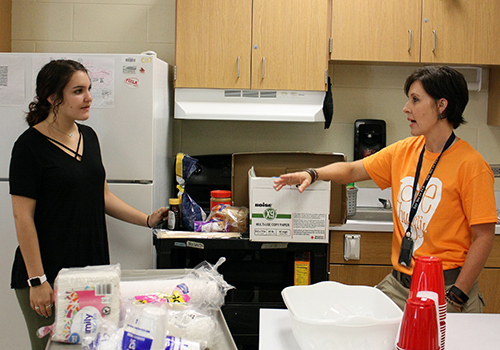 Senior Maddy Horberg and Tina Olcott plan how to take the rest of the food from the 30 hour famine breakfast back to Olcotts room last year, on April 18.