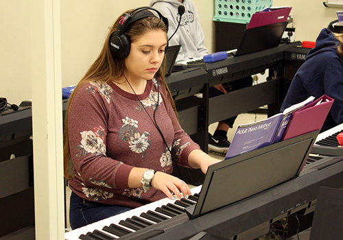 Sophomore Alex Brown practices her piano skills during seventh period piano 1 on April 10.