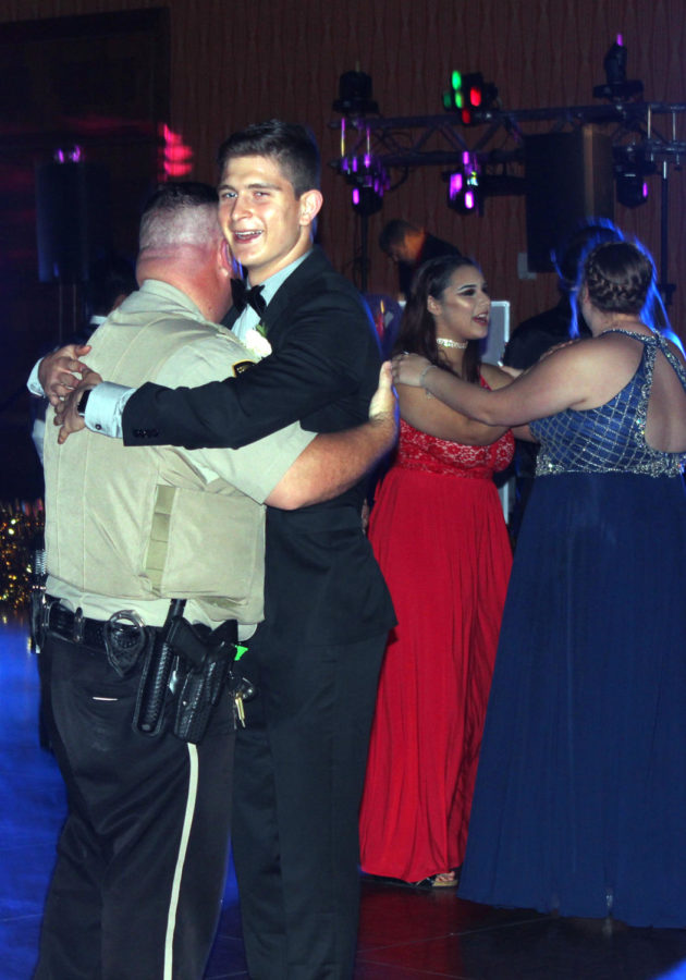 Junior Aaron Cruz dances  with one of the officers at prom. 