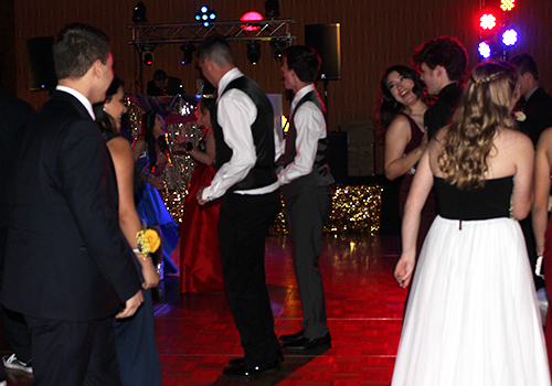 Students enjoy talking and dancing on the dance floor at prom on May 12