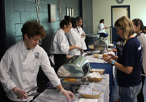 Seniors Hakey Mock, Sophia Kissel Faith Mundia, junior Denise Girarte and senior Samantha Pearson show off the skills they learned this year by serving food  they prepared to SVHS staff and family members May 4.
