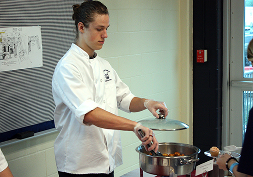 Junior Zachary Stallings serves Zeppoles for culinary on May 4.
