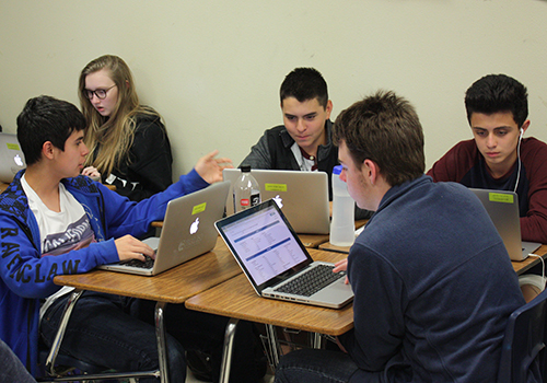 Freshmen Christian Fretitta, Emily Rose, Kevin Rodriguez, Christion Johnson, and Gabe Martinez work on a project about environmentalism in South Asia for world geography on May 10.