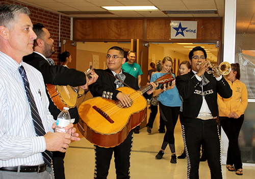 Students and staff laugh as Principal Michael Wahl was serenaded in senior dinging hall by a mariachi band for this years senior prank on May 22