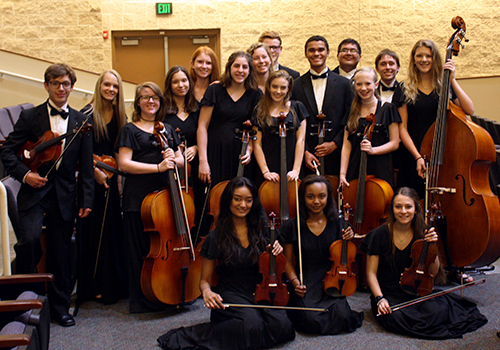 The orchestra class taking  a formal picture in the auditorium on May 25