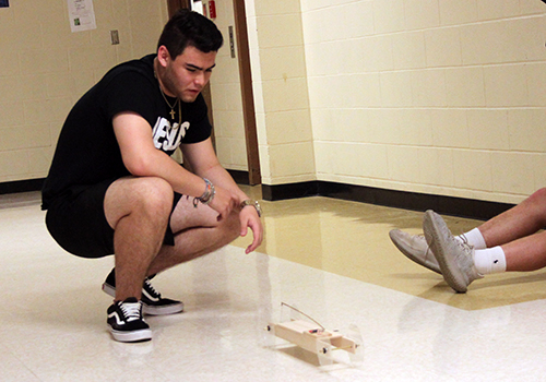 Sophomore Michael Freitas tests his mouse trap car for engineering on May 2.