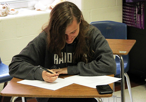 Senior Colette Montminy works on an English essay durring her off period on May 3.